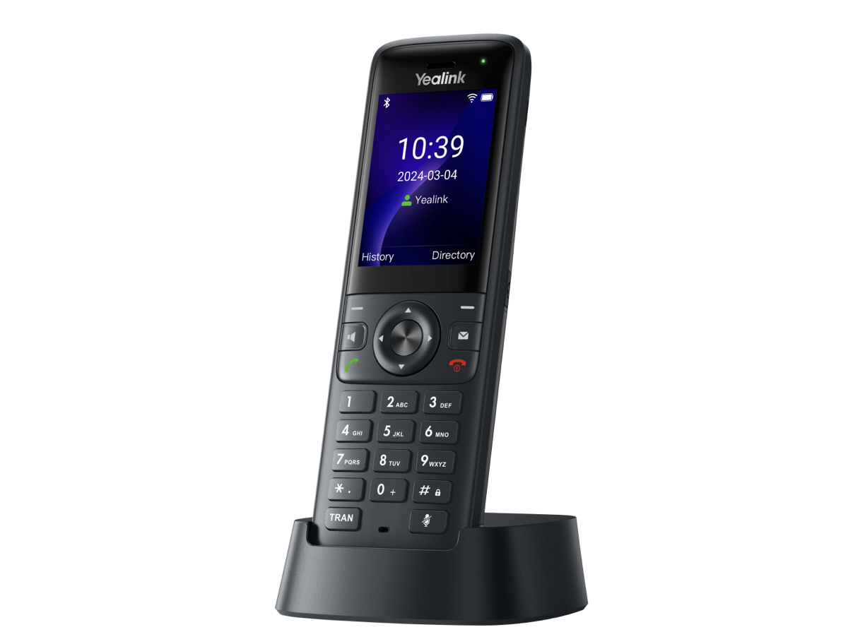 A black Yealink cordless phone stands upright in its charging dock. The display screen shows the time 10:39, the date 2024-03-04, and menu options for History and Directory.