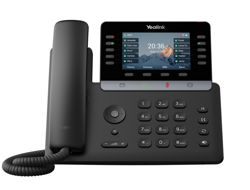 A black Yealink T74W office IP phone with a coiled cord, numeric keypad, function buttons, and a color display screen showing contact names, time, and date. This wireless model offers modern connectivity for any workspace.