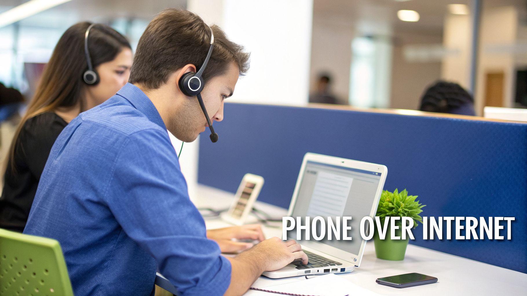 Two VOIP agents in an office wearing headsets, working on laptops, phone over internet.