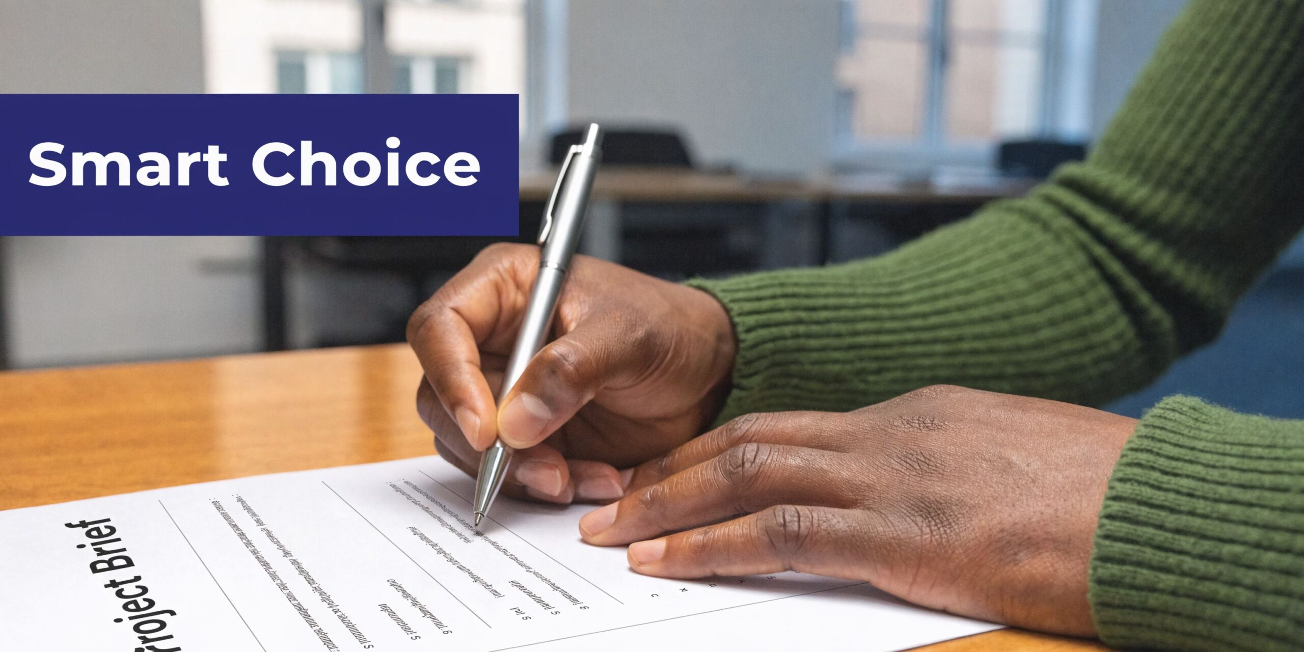 A person writing on a project brief document at a desk with a pen in hand.