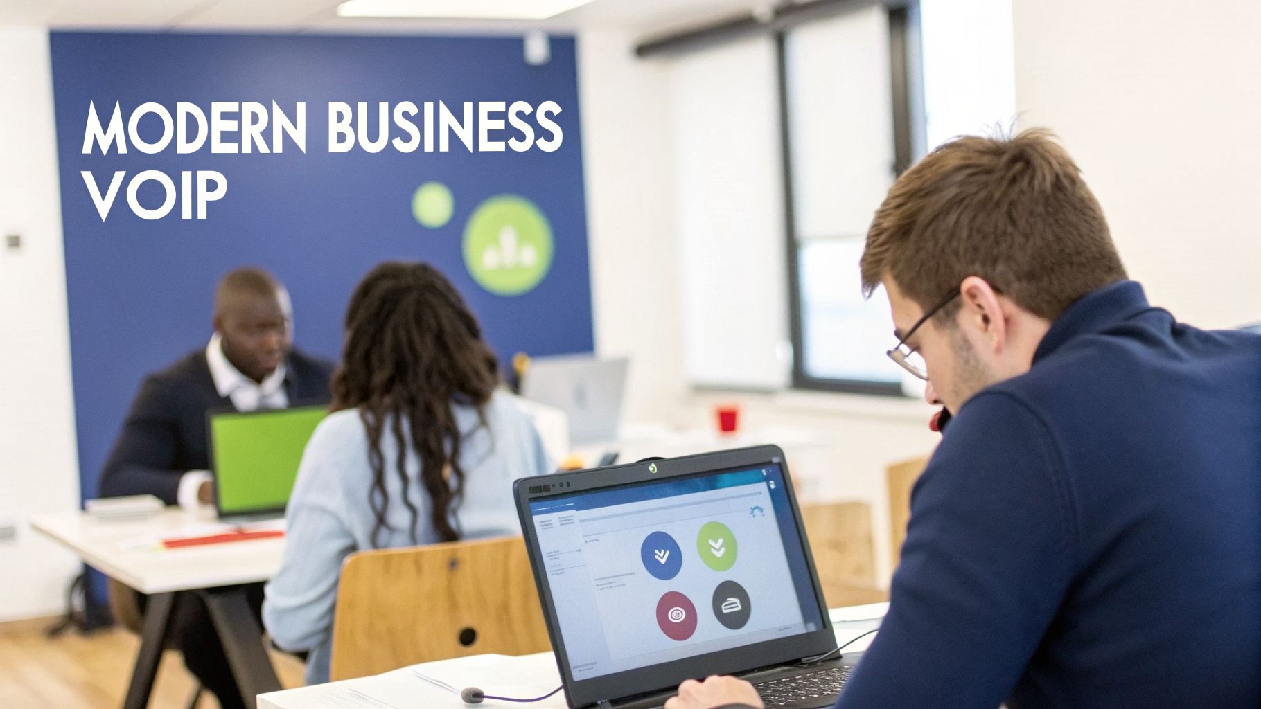 Business professionals working on laptops in a modern office, with "Modern Business VoIP" on the wall.