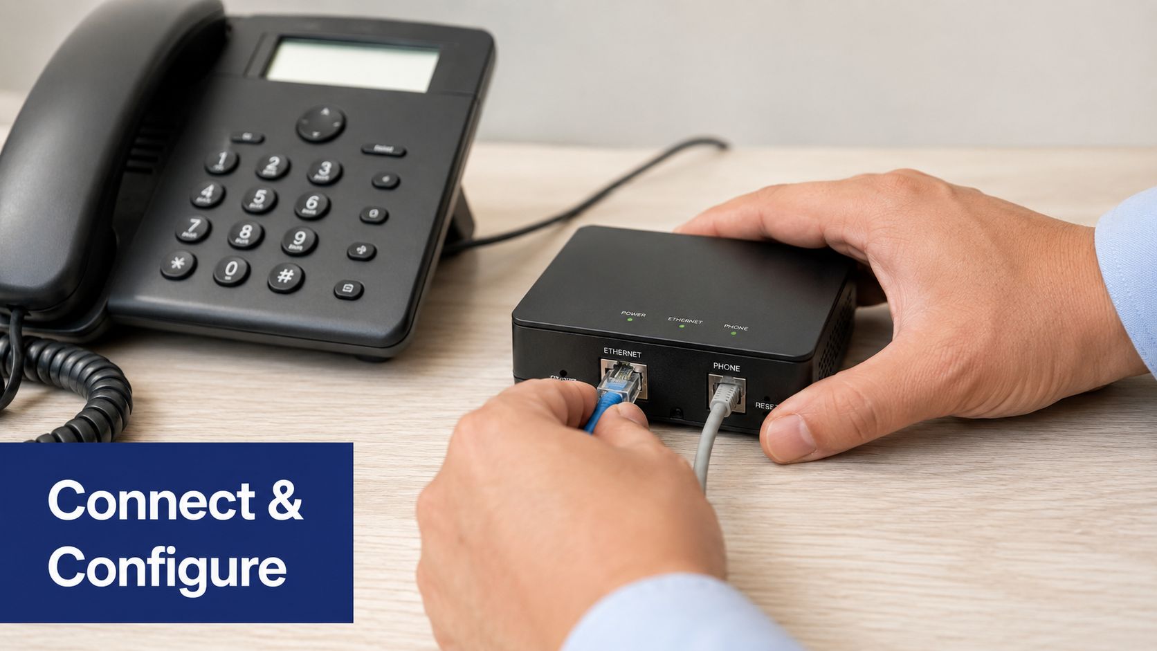A person connecting network cables into an Analog Telephone Adapter device next to a desktop office phone.