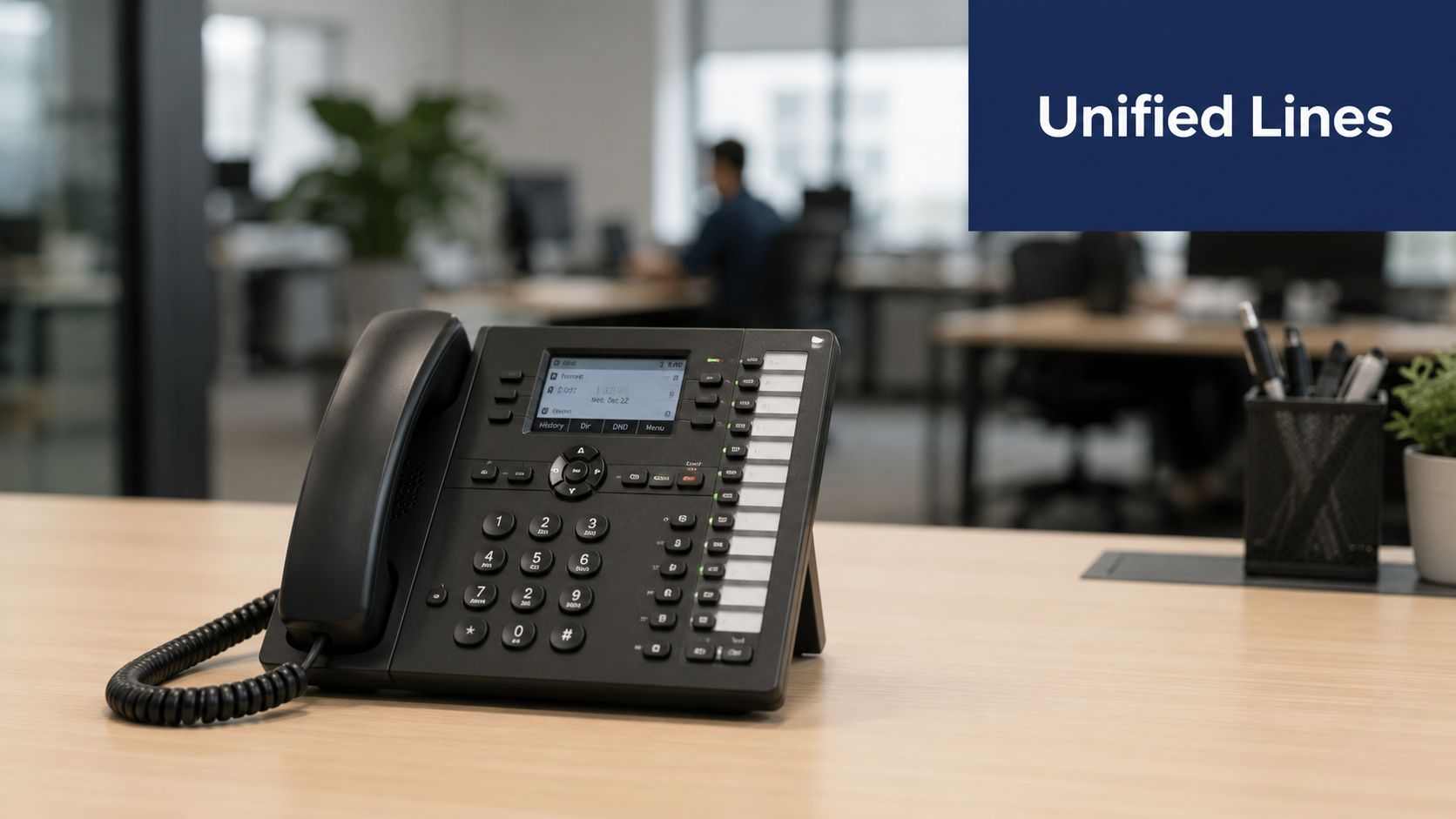 A professional VoIP desktop office phone sitting on a wooden desk in a modern corporate workspace.